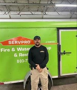 Duck facing camera in a black SERVPRO hat.